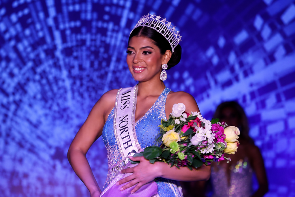 Brittany Boltinhouse Dethroned as Miss North Carolina USA 2026 Over Resurfaced Social Media Posts Brittany Boltinhouse wearing the Miss North Carolina USA crown and sash while holding a bouquet before her title was revoked in August 2026.