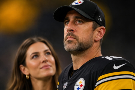 Aaron Rodgers in Steelers uniform with his wife Brittani in the background